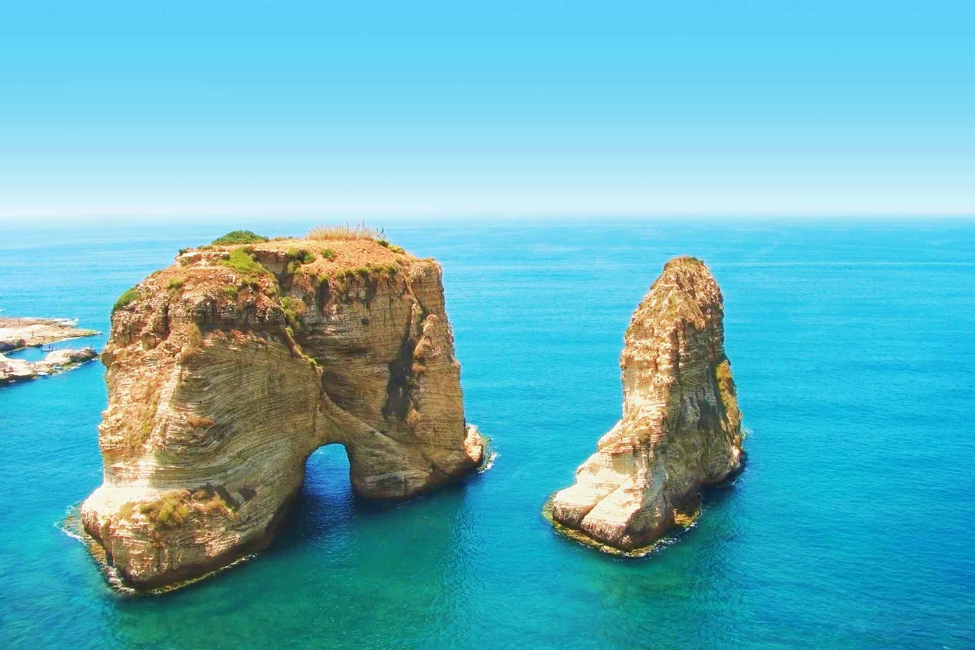 Scenic coastal rock formations with natural arch in turquoise Mediterranean waters, Beirut Lebanon